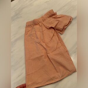 Off the shoulder peach women’s shirt.